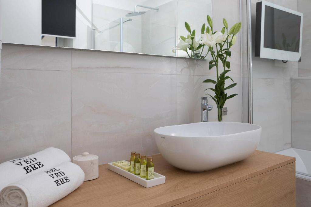 a bathroom with a white bowl sink and a mirror at Belvedere Luxury Rooms - Breathtaking View in Split