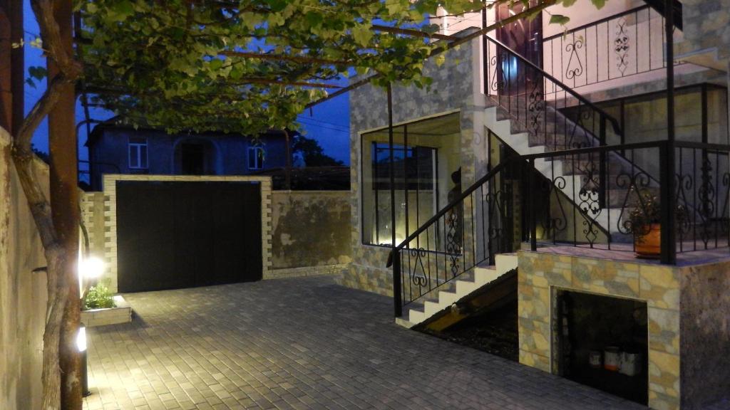 a house with a staircase and a gate and a building at Nita Apartment in K'obulet'i