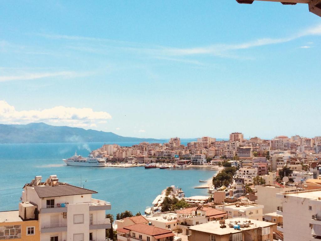 a view of a city with a cruise ship in the water at Hotel Gjika in Sarandë