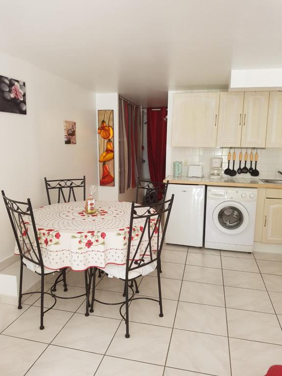 a kitchen with a table and chairs in a kitchen at Casa Prescilia in Lumio