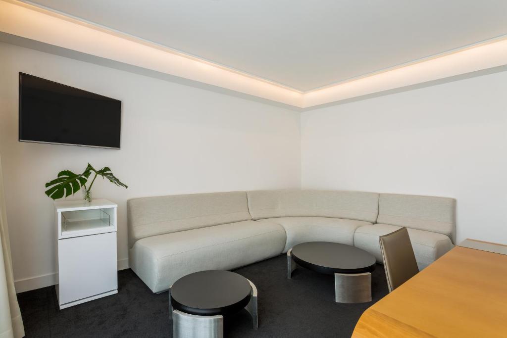 a living room with a couch and a tv at Room Mate Oscar, Madrid in Madrid