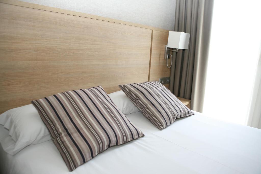 Postel nebo postele na pokoji v ubytování Hotel Terminus
