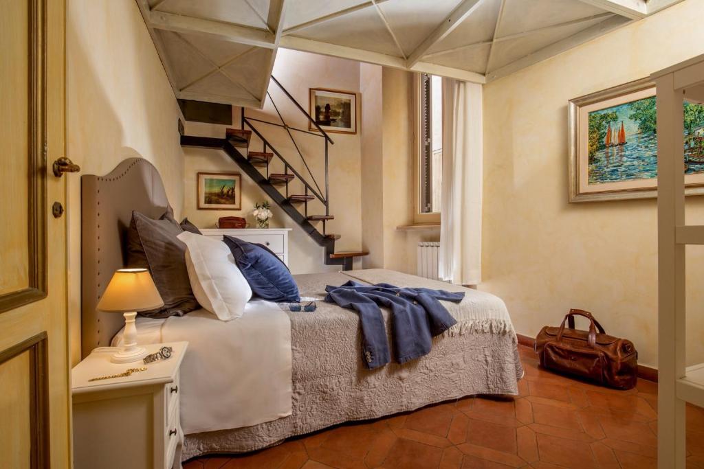 a bedroom with a large bed with a staircase at Antica dimora navona in Rome
