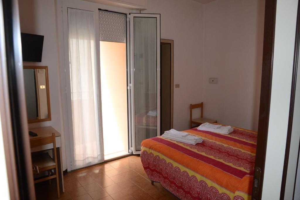 Postel nebo postele na pokoji v ubytování Albergo Larenzia