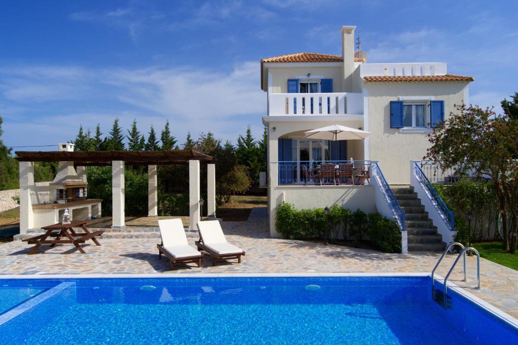 a villa with a swimming pool and a house at Eglina Villa's in Minia