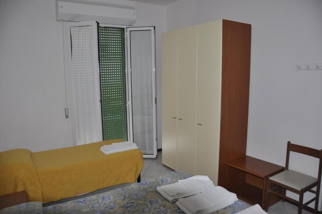 Postel nebo postele na pokoji v ubytování Albergo Larenzia
