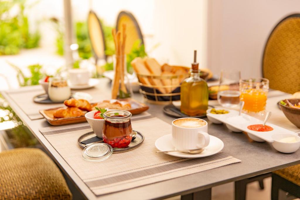a table with breakfast foods and drinks on it at ICON Rosetó in Palma de Mallorca