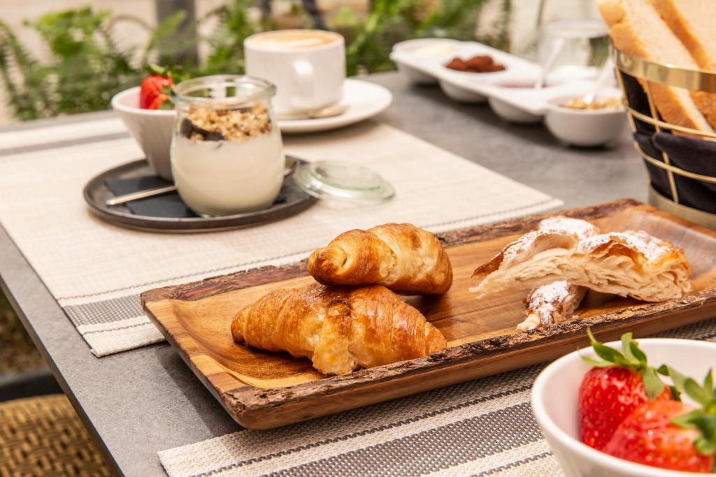 a table with a tray of croissants and a plate of food at ICON Rosetó in Palma de Mallorca