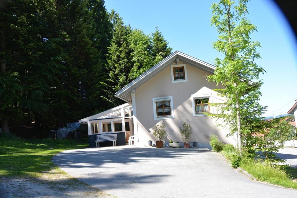 a white house with a driveway at Haus Jasmin in Hauzenberg