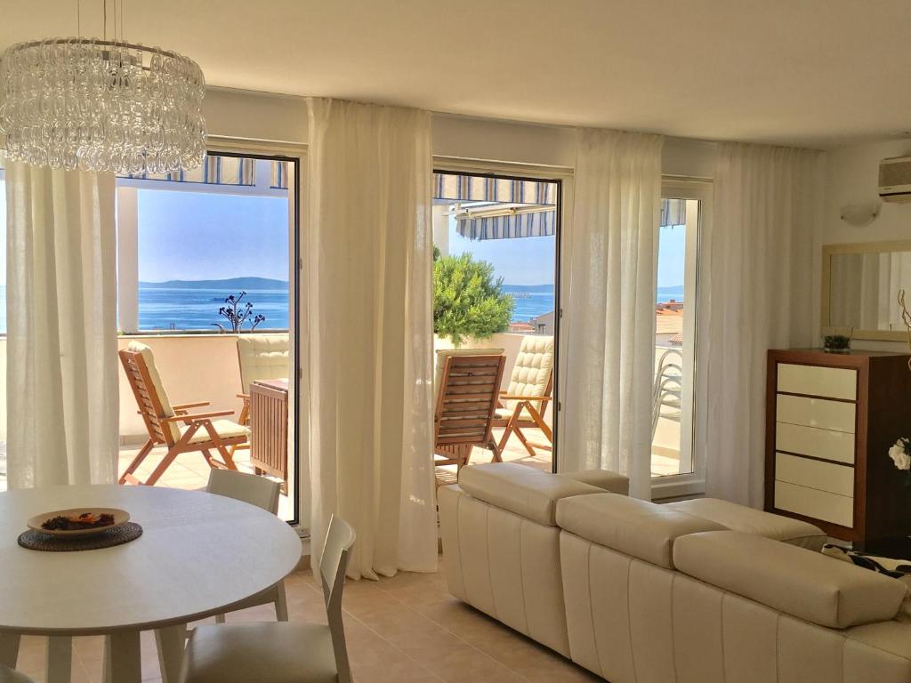 a living room with a couch and a table at Beach Apartment Lux View in Split