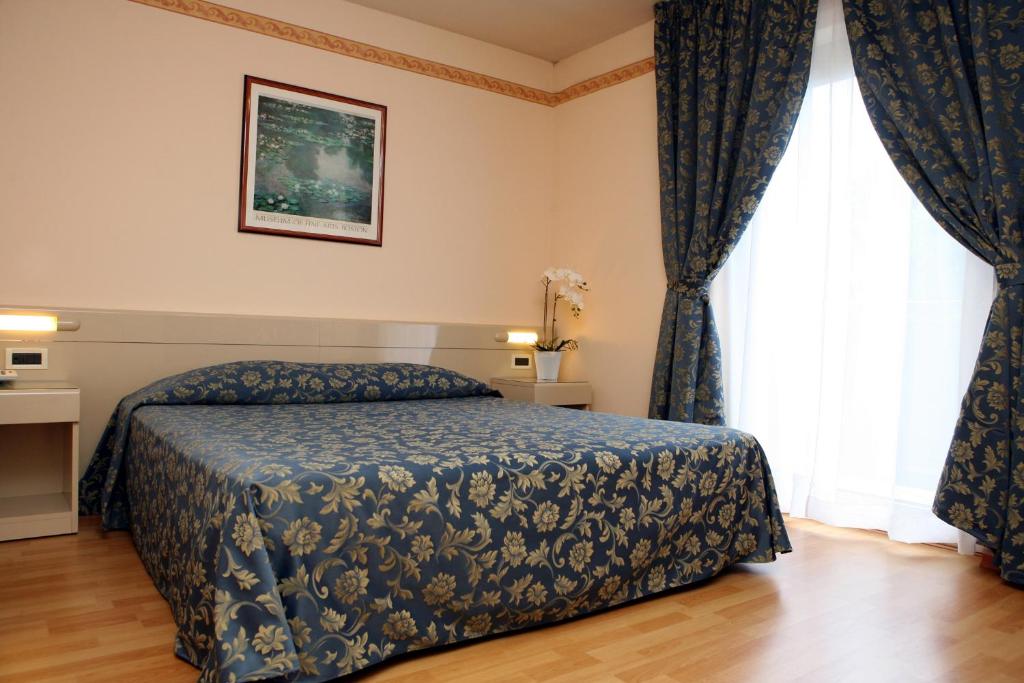 Posteľ alebo postele v izbe v ubytovaní Hotel Excelsior