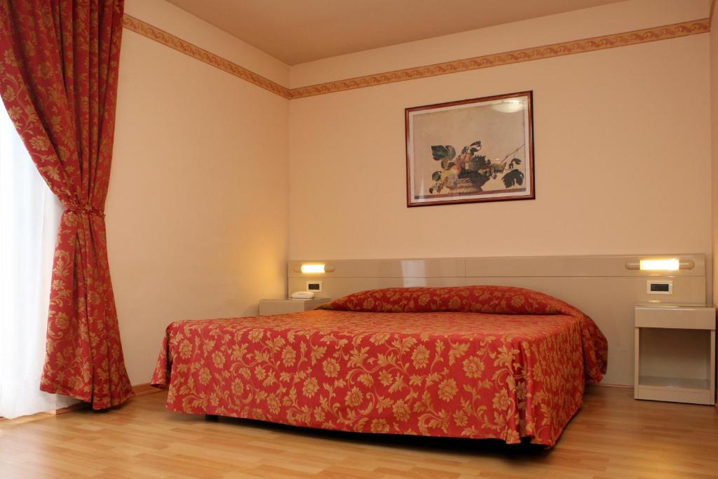 Posteľ alebo postele v izbe v ubytovaní Hotel Excelsior