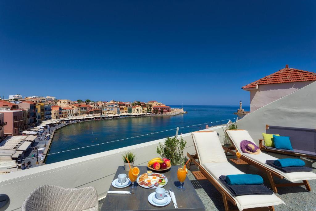 a balcony with a view of the water at 1924 suites in Chania