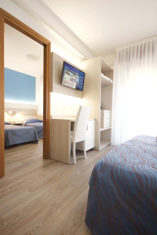Postel nebo postele na pokoji v ubytování Hotel Serenella