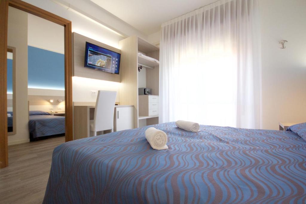 Postel nebo postele na pokoji v ubytování Hotel Serenella