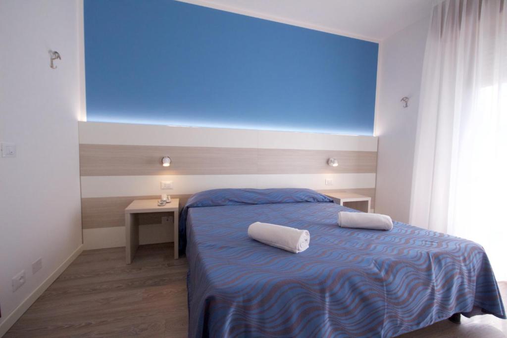 Postel nebo postele na pokoji v ubytování Hotel Serenella