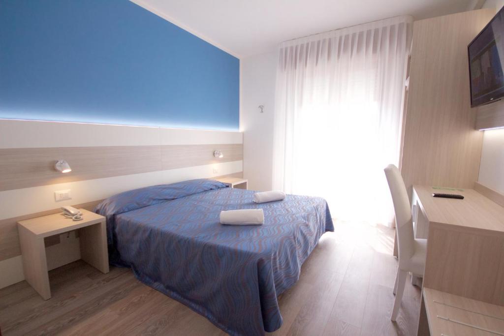 Postel nebo postele na pokoji v ubytování Hotel Serenella
