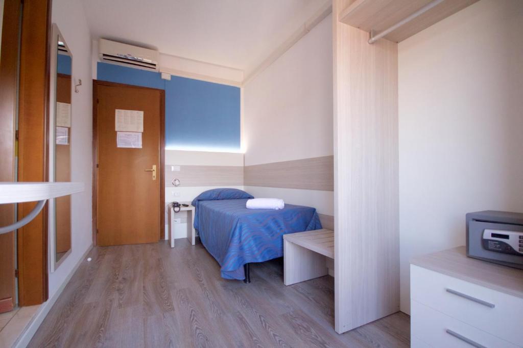 Postel nebo postele na pokoji v ubytování Hotel Serenella