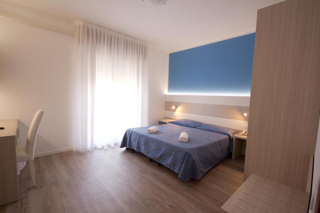 Postel nebo postele na pokoji v ubytování Hotel Serenella