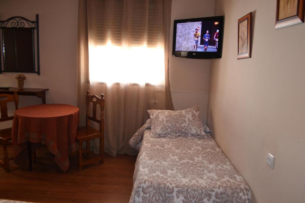 Posteľ alebo postele v izbe v ubytovaní Hostal Pension La Ruta