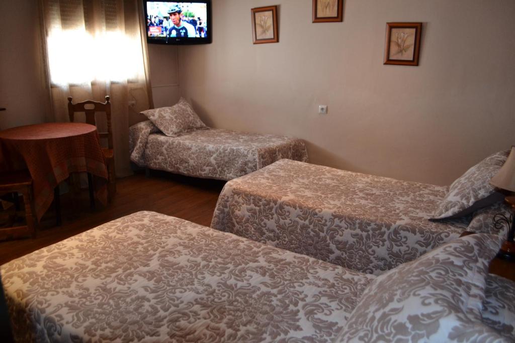 Posteľ alebo postele v izbe v ubytovaní Hostal Pension La Ruta