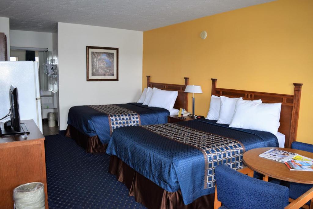 a hotel room with two beds and a television at Bluegrass Extended Stay in Lexington