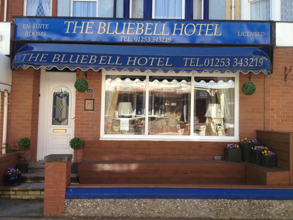 a restaurant with a blue sign on the front of a building at Bluebell Hotel in Blackpool
