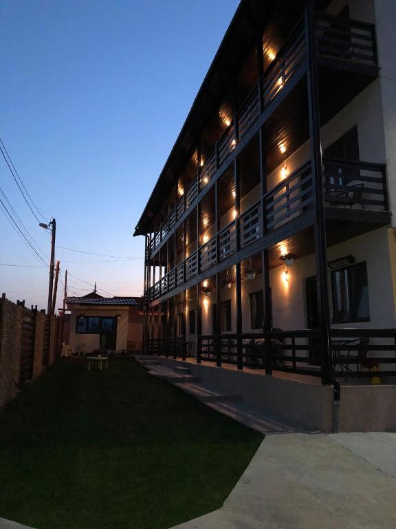 a large building with lights on the side of it at Vila Natalia in Vama Veche