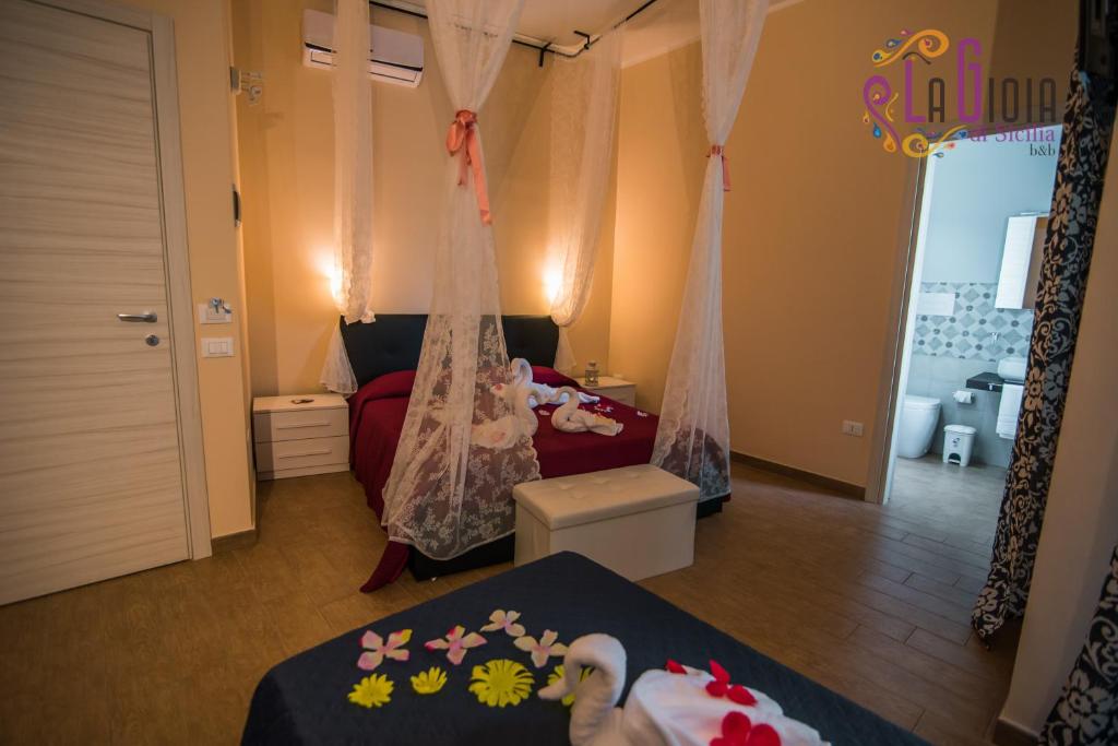 Postel nebo postele na pokoji v ubytování La Gioia di Sicilia B&B