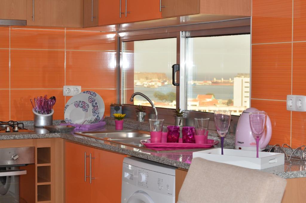 a kitchen with a sink and a counter with a window at Apartamento Cristina in Praia