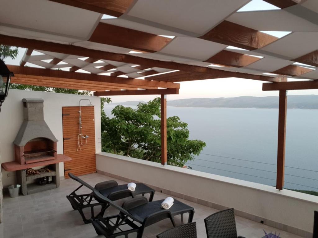 a patio with a view of the water at Grandpa's dream in Lokva Rogoznica