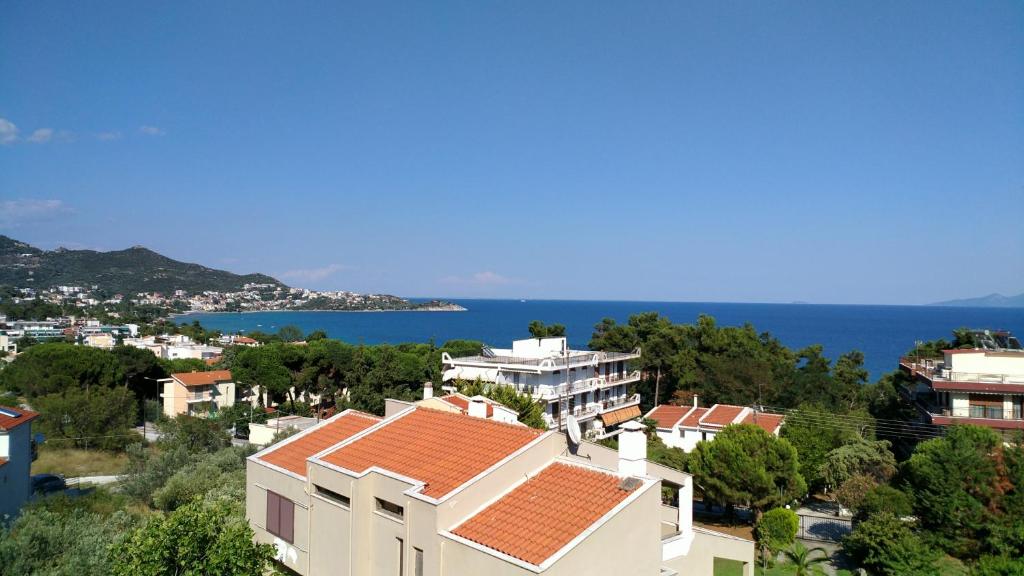 a view of a city with houses and the ocean at Sweet home with spectacular sea view in Paleo Tsifliki