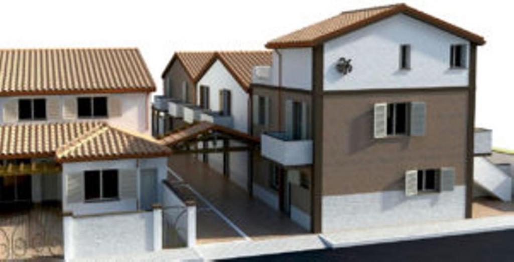 eine Reihe von Häusern mit Dächern auf einem Gebäude in der Unterkunft Casa Vacanze Calabro' in SantʼAntìoco