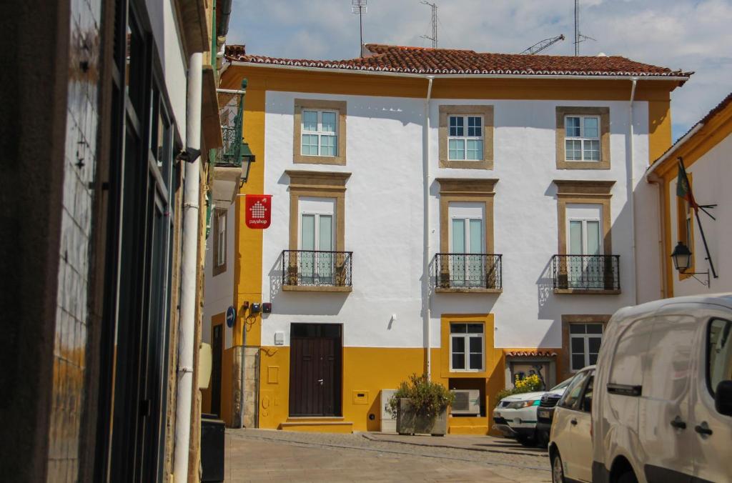 
a car parked in front of a building next to a building at Casa do Arco Portalegre in Portalegre
