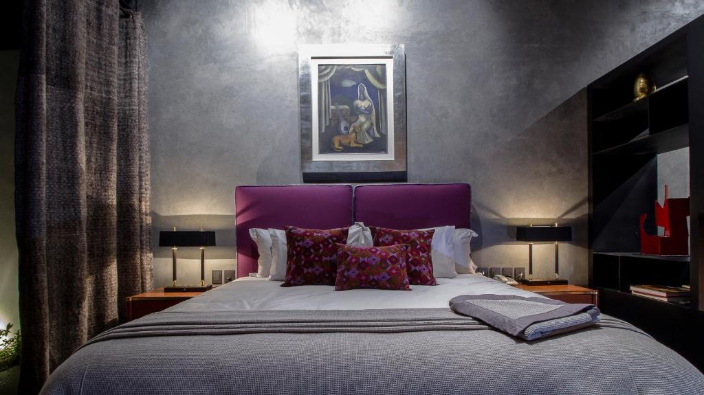 Postel nebo postele na pokoji v ubytování Uvence Arte + Hotel