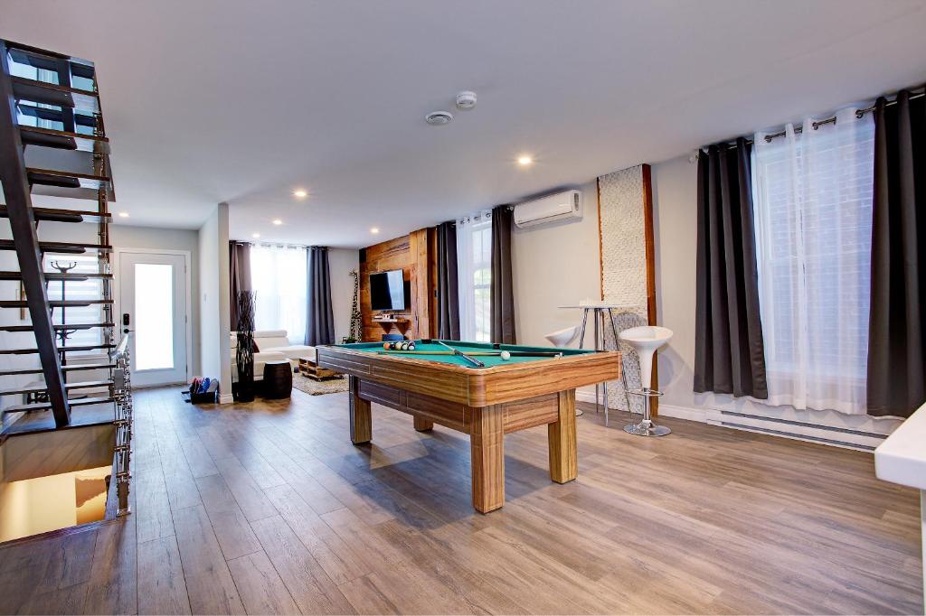 a living room with a pool table in it at Modern Townhouse with Rooftop Deck in Montreal