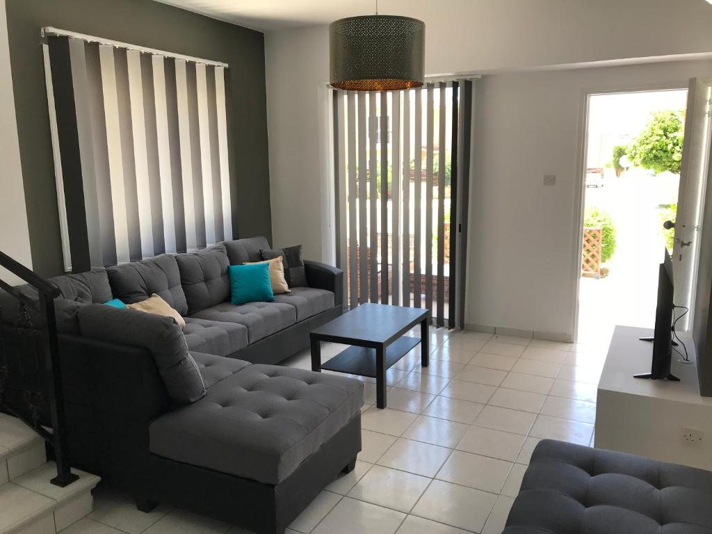 a living room with a couch and a table at Diana Townhouse 5 in Paphos