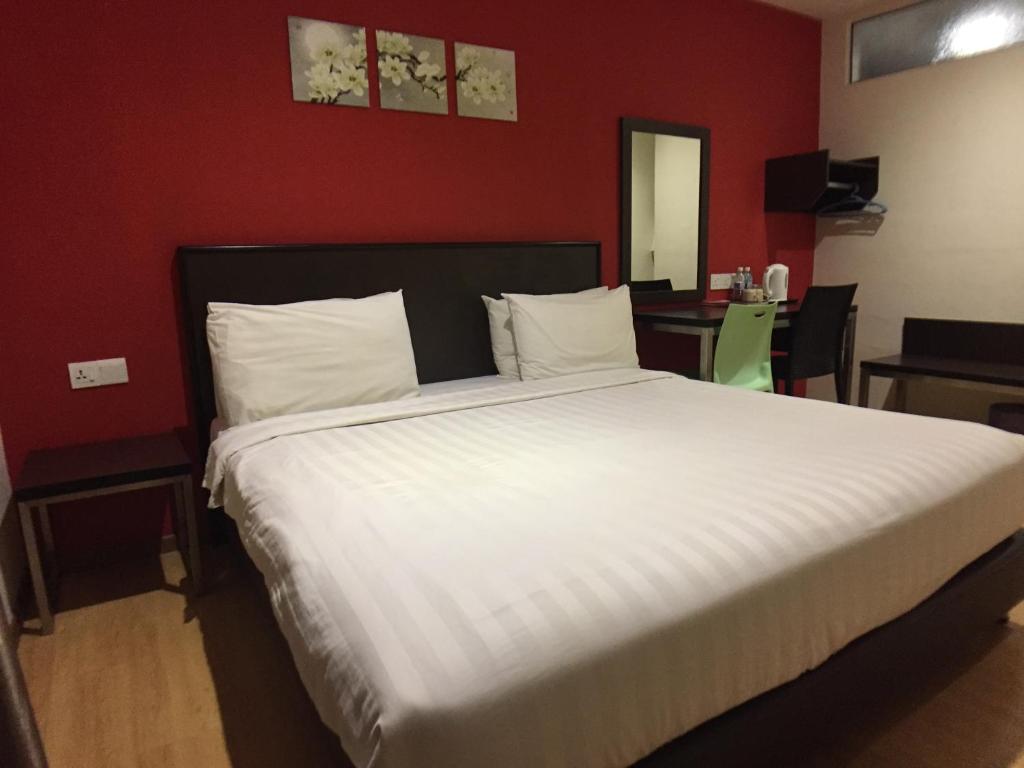 Postel nebo postele na pokoji v ubytování Padungan Hotel