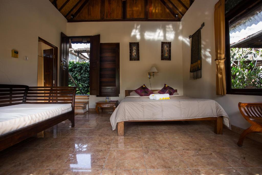 Postel nebo postele na pokoji v ubytování Bali Asli Lodge by EPS