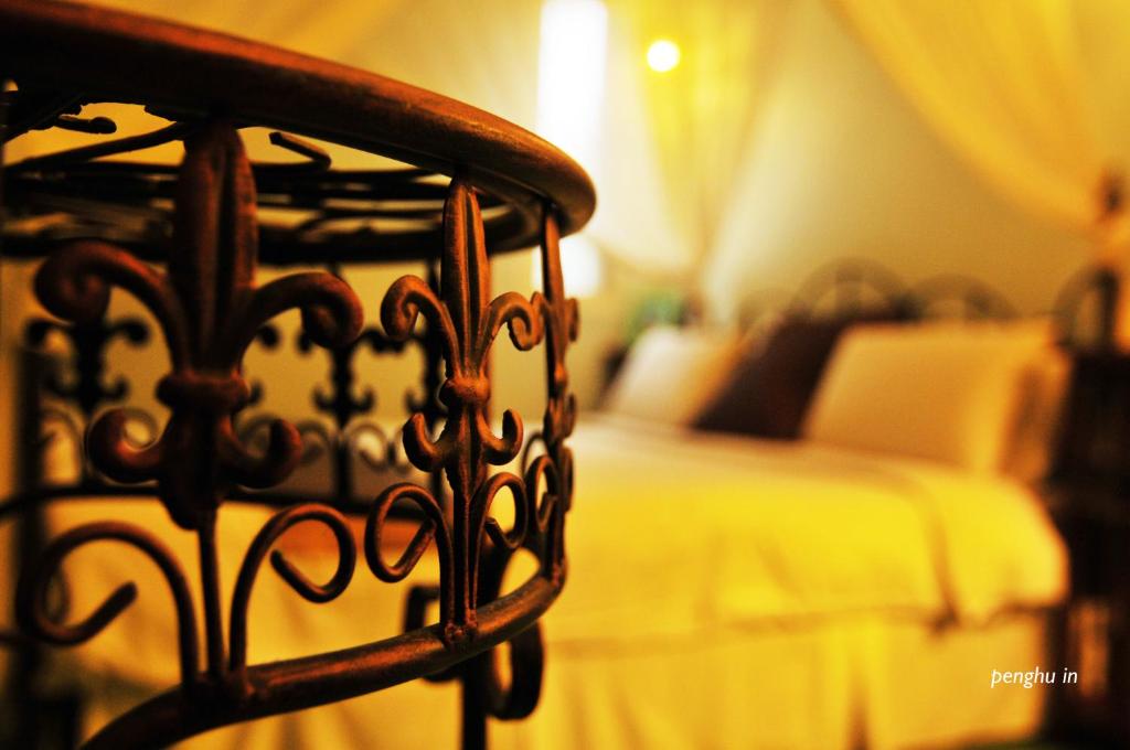 a close up of a bed frame in a bedroom at Raid Garden Boutique Hotel in Magong