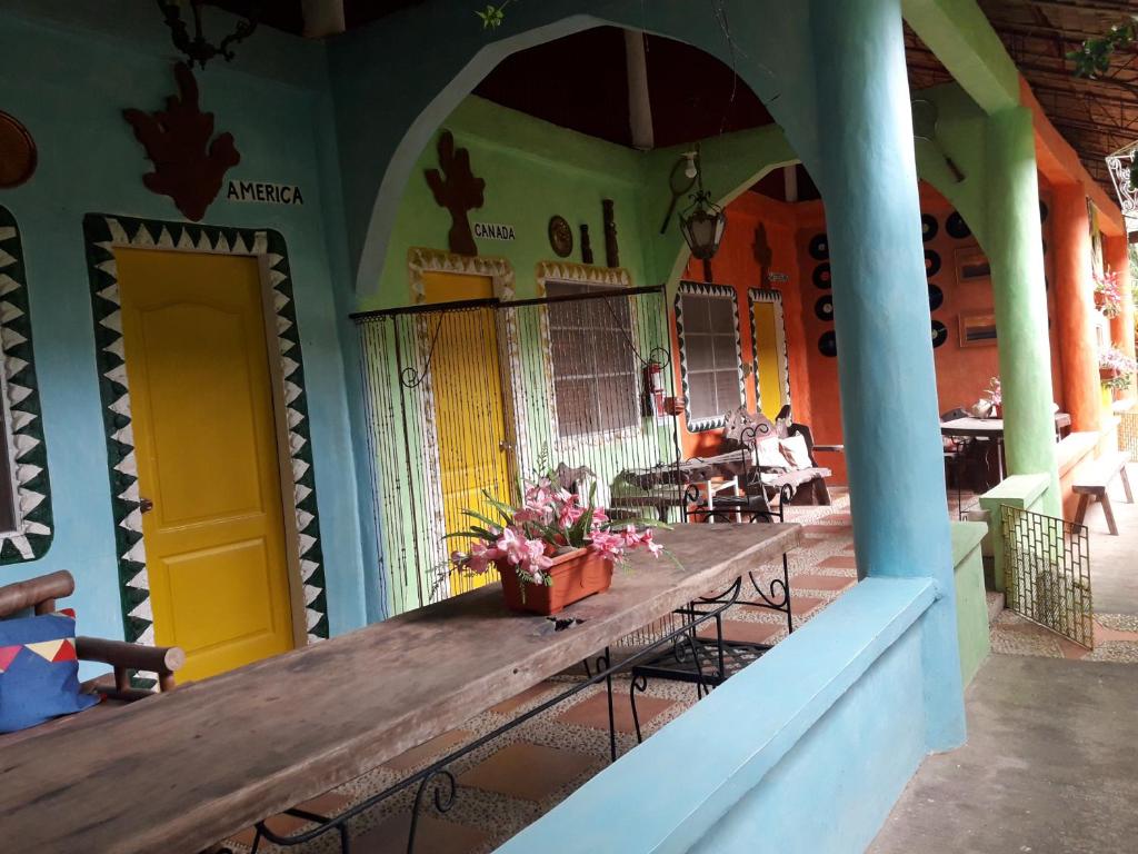 a porch with a wooden table in a building at Relaxing Garden Resort in Sara