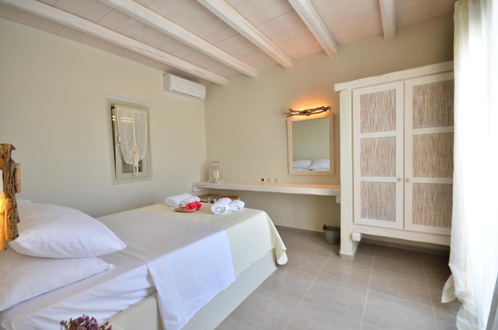 a bedroom with a bed with two stuffed animals on it at Portes Houses in Koufonisia