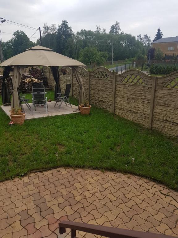 a patio with an umbrella in a yard at Pension Sunset Mezirolí in Nová Role