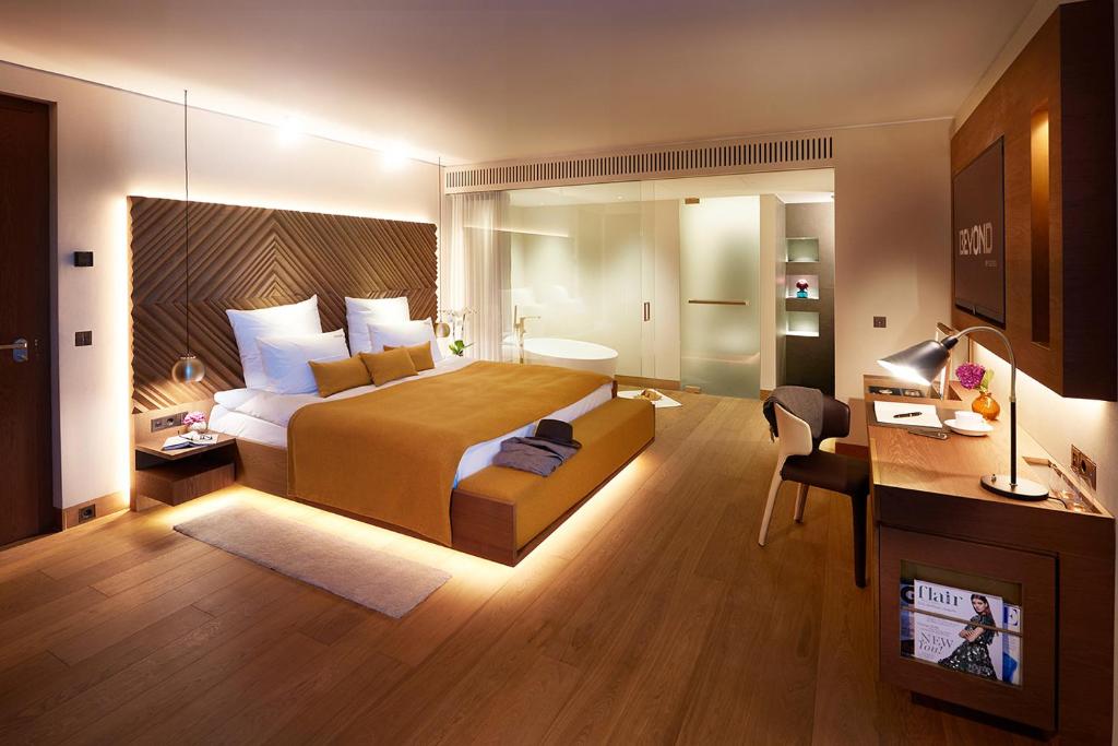 a hotel room with a bed and a desk at BEYOND by Geisel - Adults only in Munich