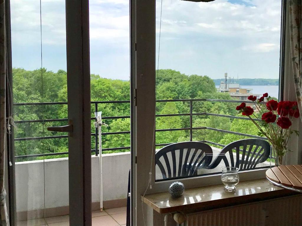 a balcony with two chairs and a view of the water at Gluecksburg 2 _ Ferienwohnung 3822 in Ulstrupfeld