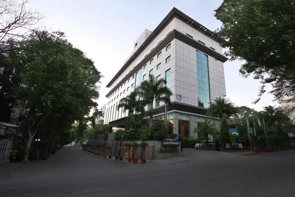 a large white building on a city street at Fortune Select JP Cosmos, Bengaluru - Member ITC's hotel group in Bangalore