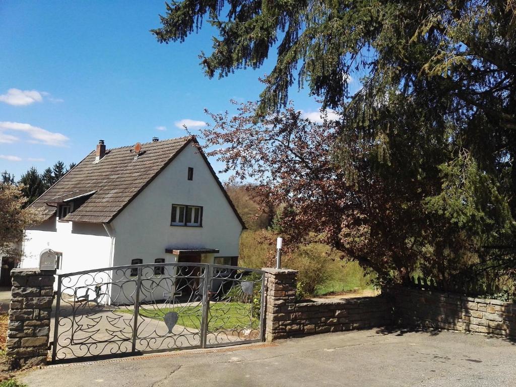a white house with a gate in front of it at Holiday Home in Filz near River in Filz