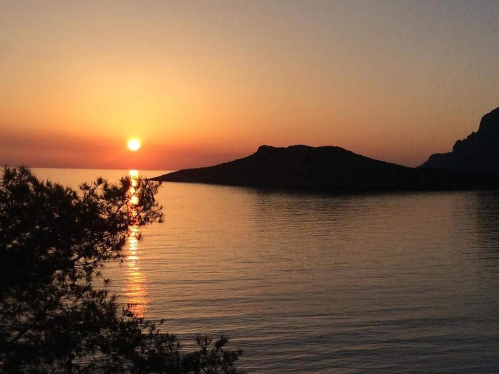 a sunset over a body of water with mountains at Villa Mela in Kalymnos