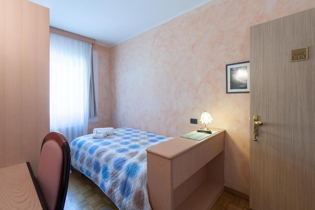 Postel nebo postele na pokoji v ubytování Grand Hotel Gortani