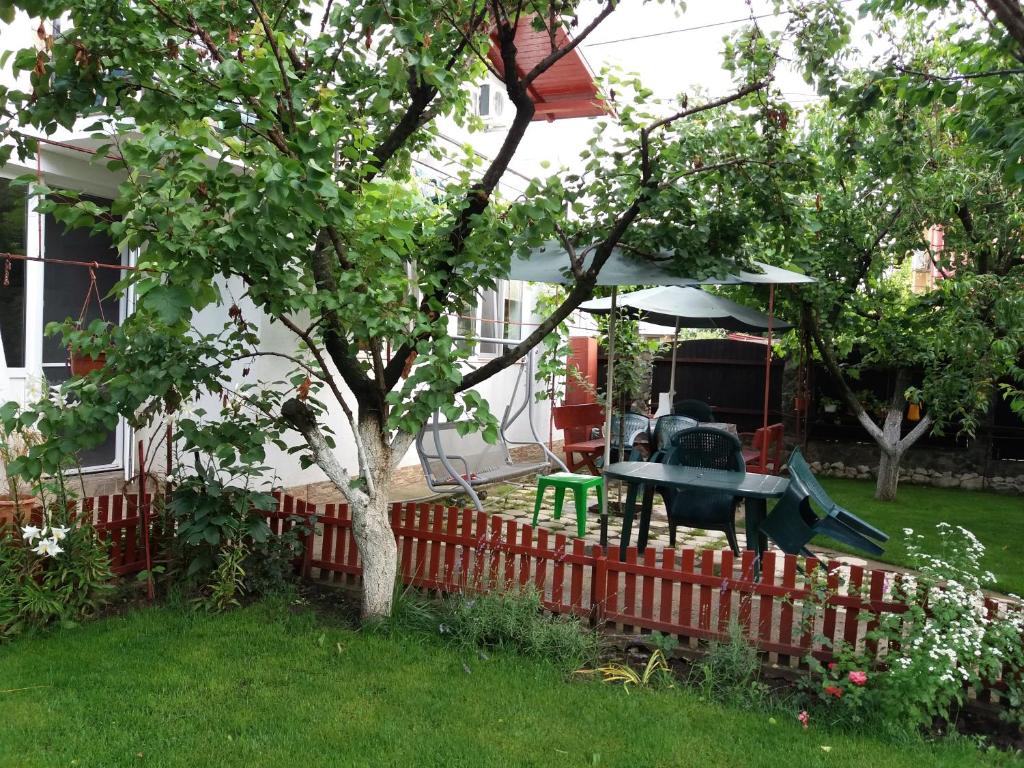 a backyard with a table and a playground at Casa cu Foisor in Eforie Nord